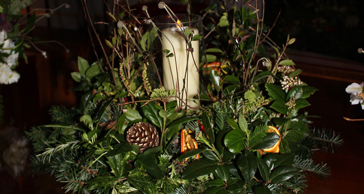 Christmas flower arrangement with a candle 